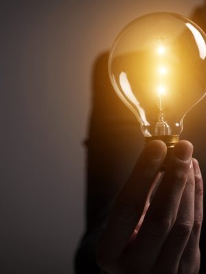 Businessman holding a glowing light bulb